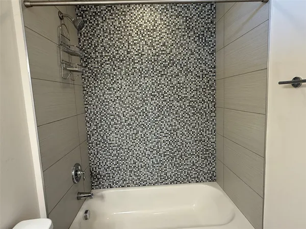 a bathroom with a bathtub and shower