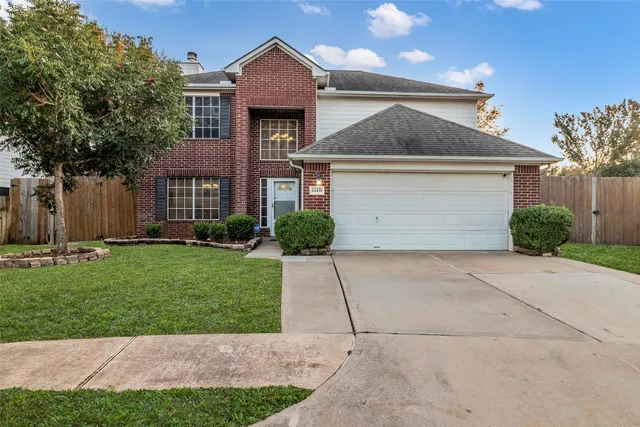 a front view of a house with a yard and a garage