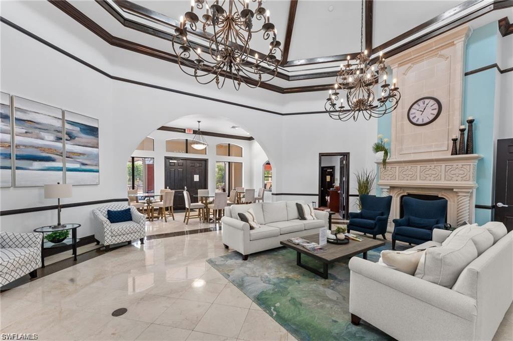 12975 Positano Circle, Unit 202 Naples, FL 34105 - Photo 14 of 14 a living room with furniture a large window and a fireplace