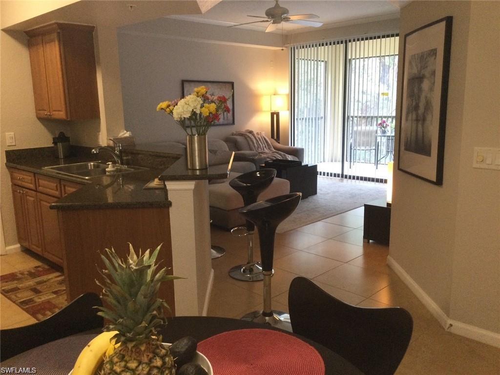 12975 Positano Circle, Unit 202 Naples, FL 34105 - Photo 5 of 14 a living room with furniture