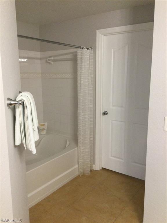 12975 Positano Circle, Unit 202 Naples, FL 34105 - Photo 8 of 14 a bathroom with a shower and a sink