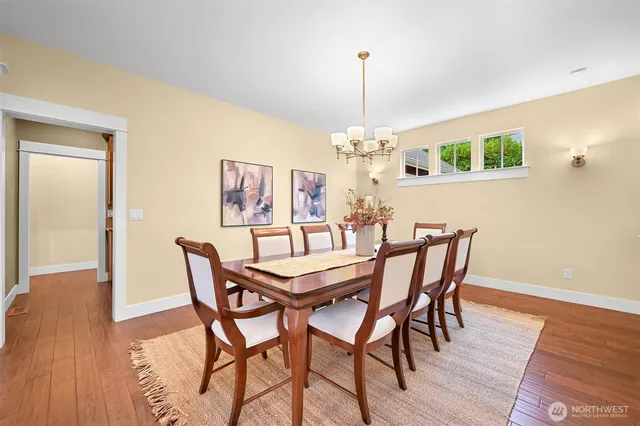 a view of a dining room with furniture wooden floor and chandelier