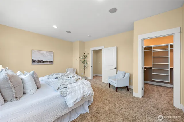 a spacious bedroom with a bed and furniture