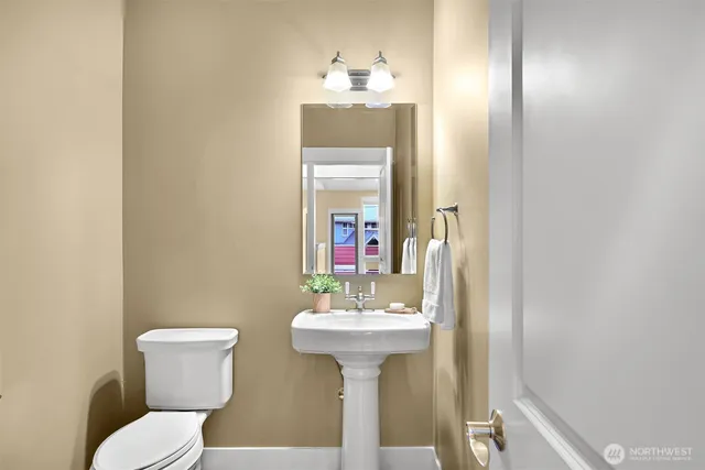 a bathroom with a sink a mirror and a toilet