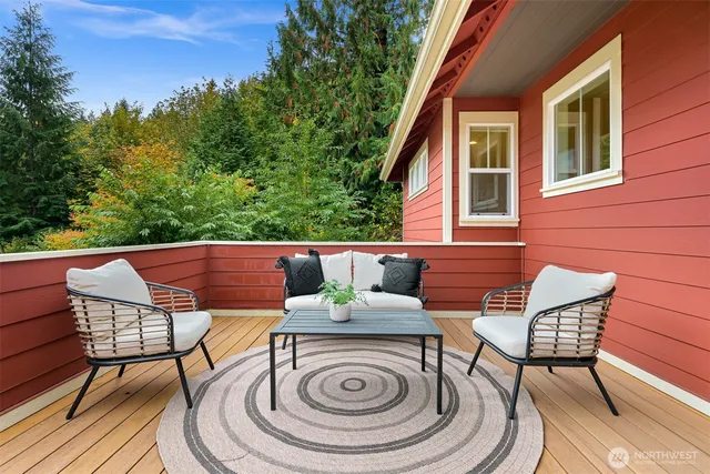 a view of a patio with table and chairs with wooden floor and fence