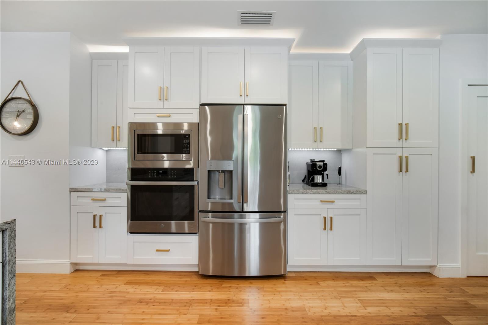 13001 Southwest 70th Avenue Pinecrest, FL 33156 - Photo 19 of 49 a kitchen with stainless steel appliances a refrigerator stove and microwave
