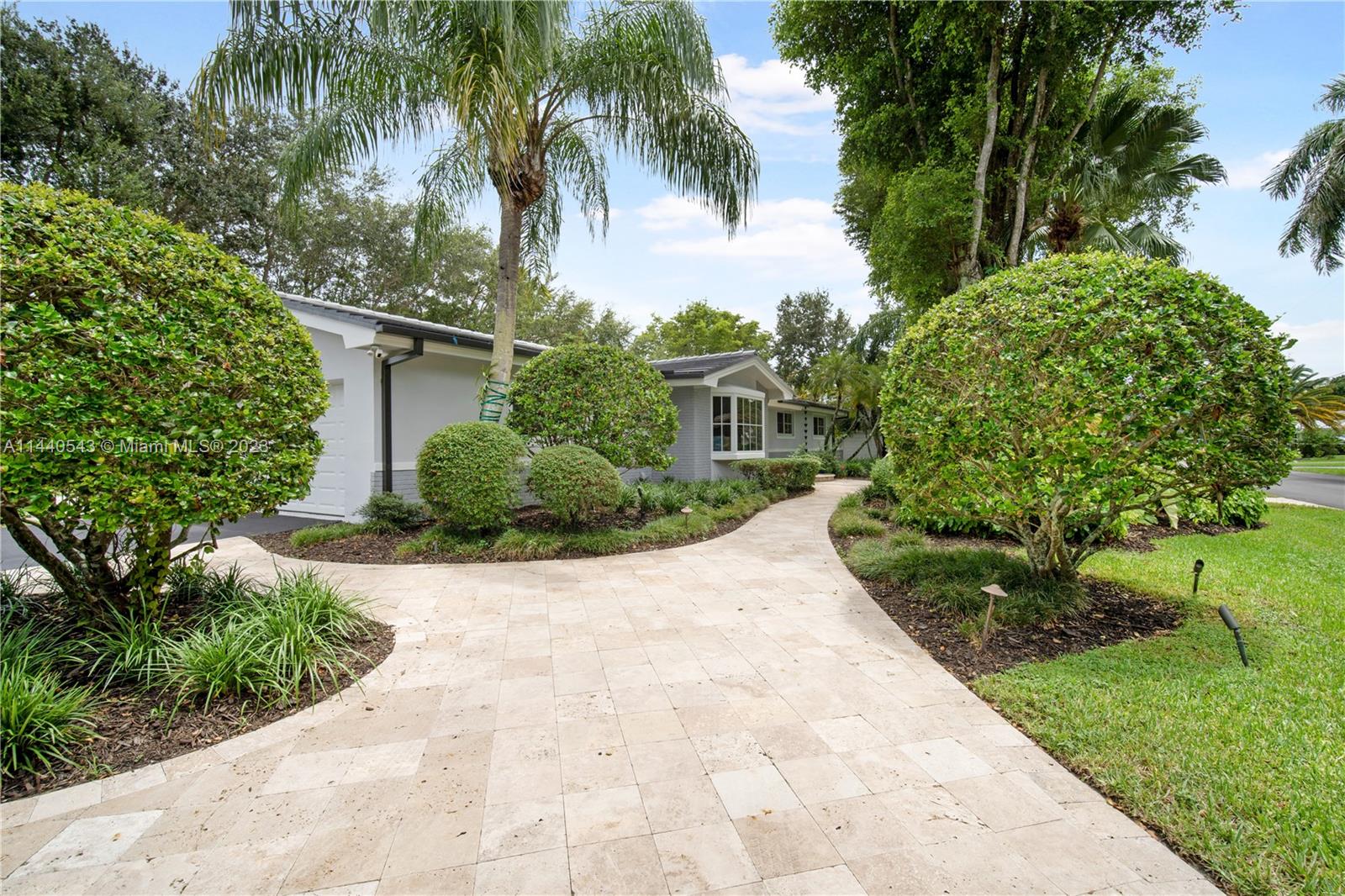 13001 Southwest 70th Avenue Pinecrest, FL 33156 - Photo 2 of 49 a view of a yard with plants and palm trees