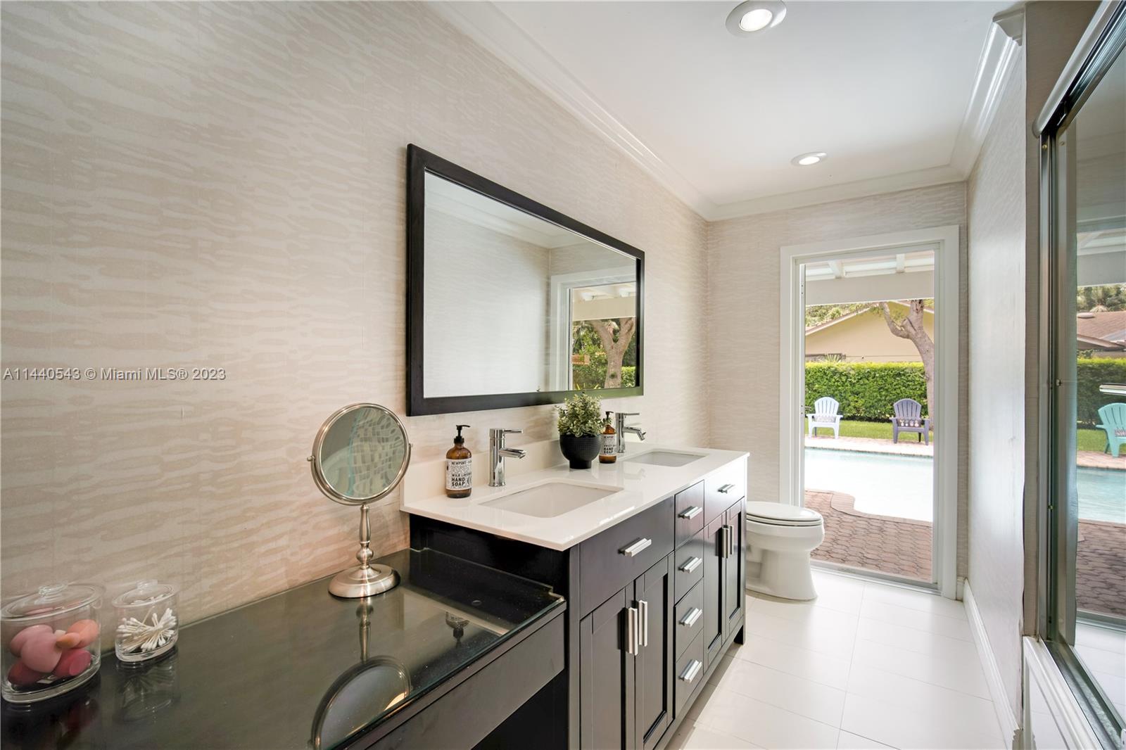 13001 Southwest 70th Avenue Pinecrest, FL 33156 - Photo 26 of 49 a bathroom with a sink mirror and a bathtub