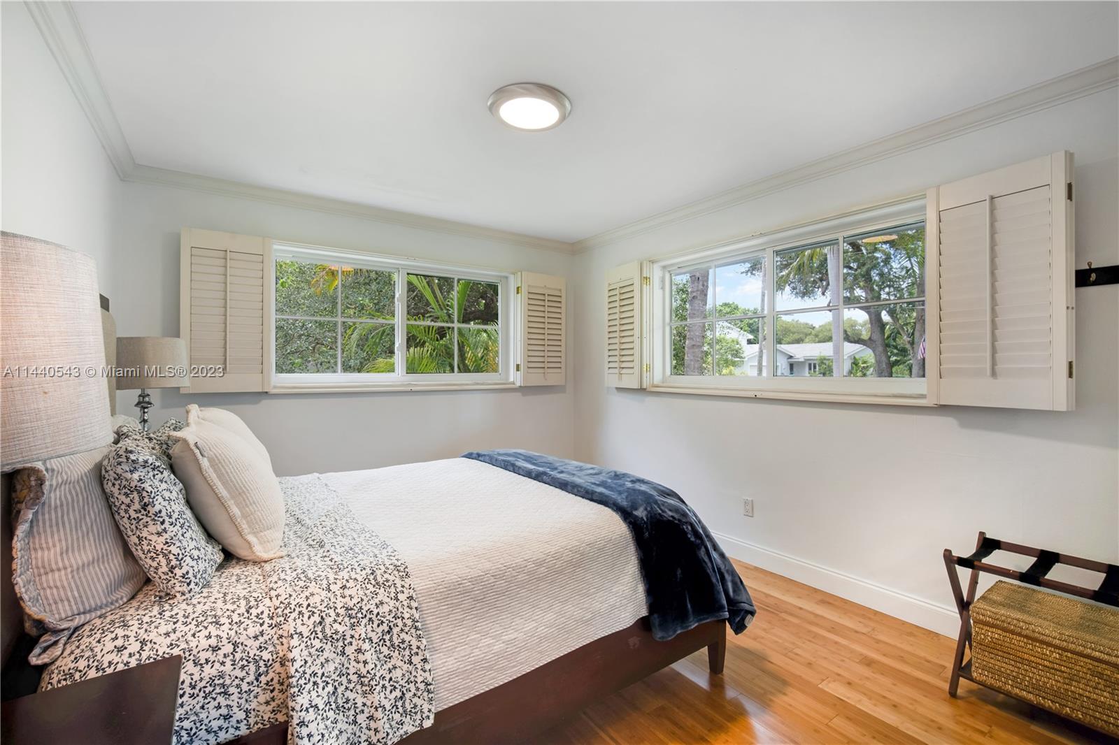 13001 Southwest 70th Avenue Pinecrest, FL 33156 - Photo 27 of 49 a bedroom with a bed and wooden floor