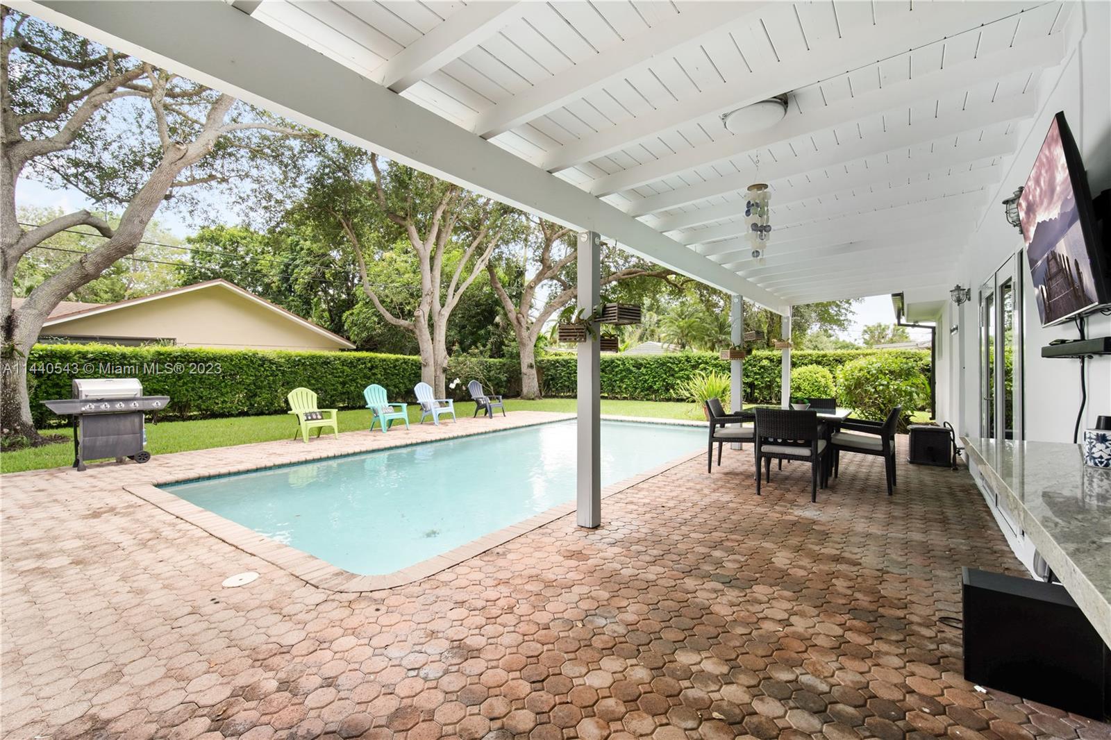 13001 Southwest 70th Avenue Pinecrest, FL 33156 - Photo 32 of 49 a view of a swimming pool with a patio