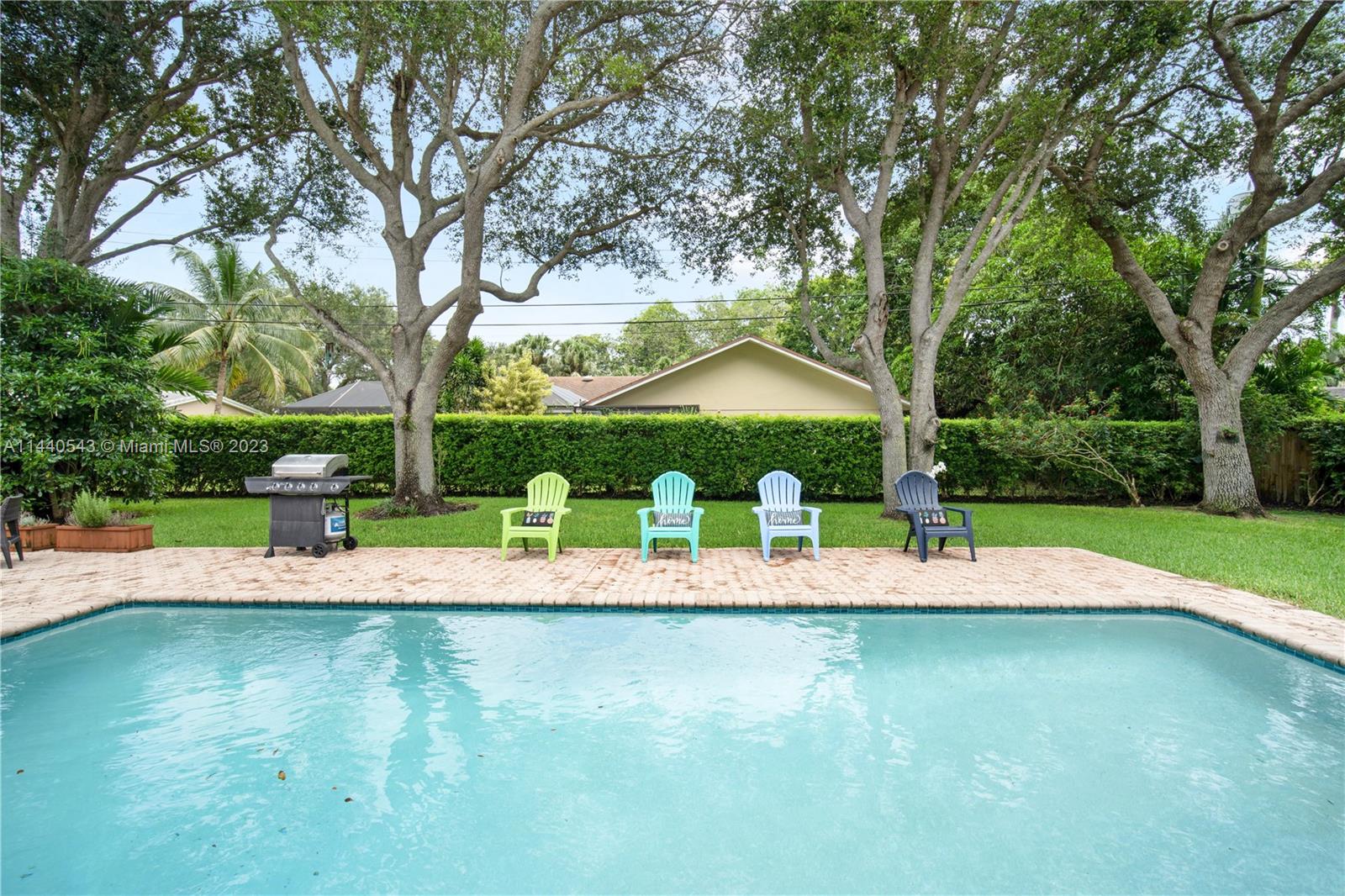 13001 Southwest 70th Avenue Pinecrest, FL 33156 - Photo 35 of 49 a view of a swimming pool with a patio