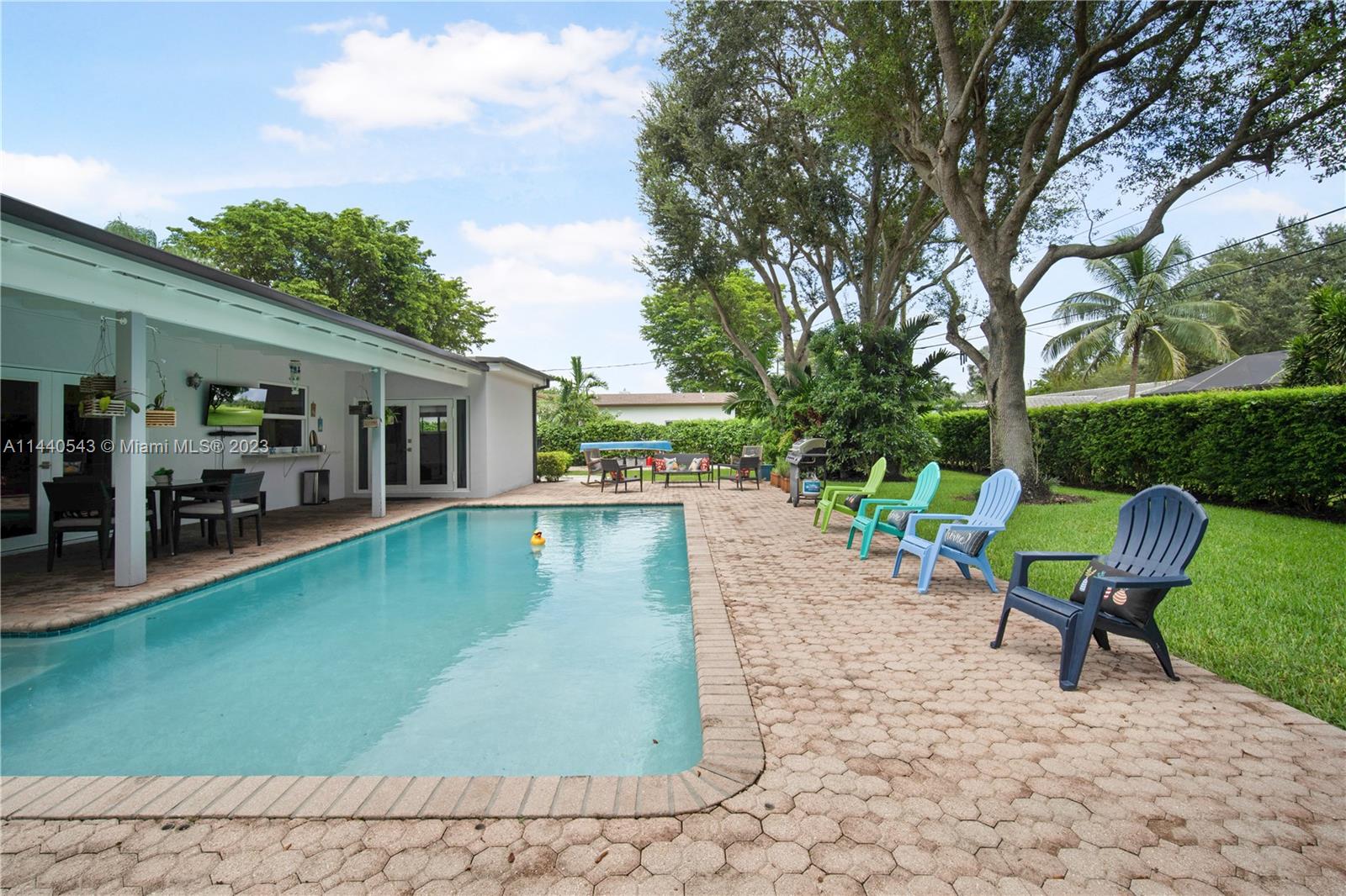 13001 Southwest 70th Avenue Pinecrest, FL 33156 - Photo 36 of 49 a view of a house with swimming pool and sitting area