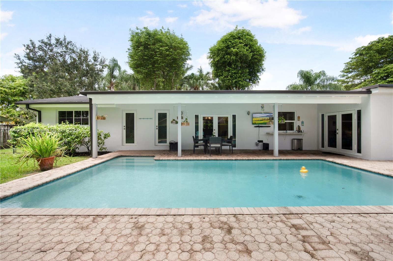 13001 Southwest 70th Avenue Pinecrest, FL 33156 - Photo 37 of 49 a view of a house with pool backyard and chairs