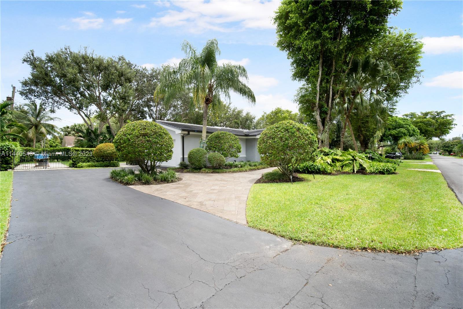 13001 Southwest 70th Avenue Pinecrest, FL 33156 - Photo 43 of 49 a view of a garden with a pathway and a garden