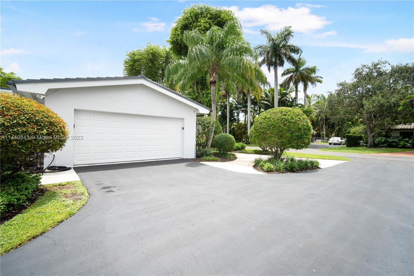 13001 Southwest 70th Avenue Pinecrest, FL 33156 - Photo 44 of 49 a view of a house with a yard and garage