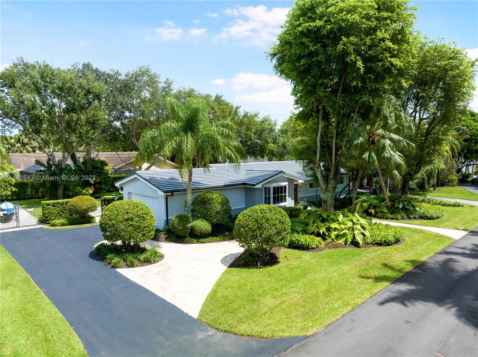 13001 Southwest 70th Avenue Pinecrest, FL 33156 - Photo 45 of 49 a view of a garden with a house