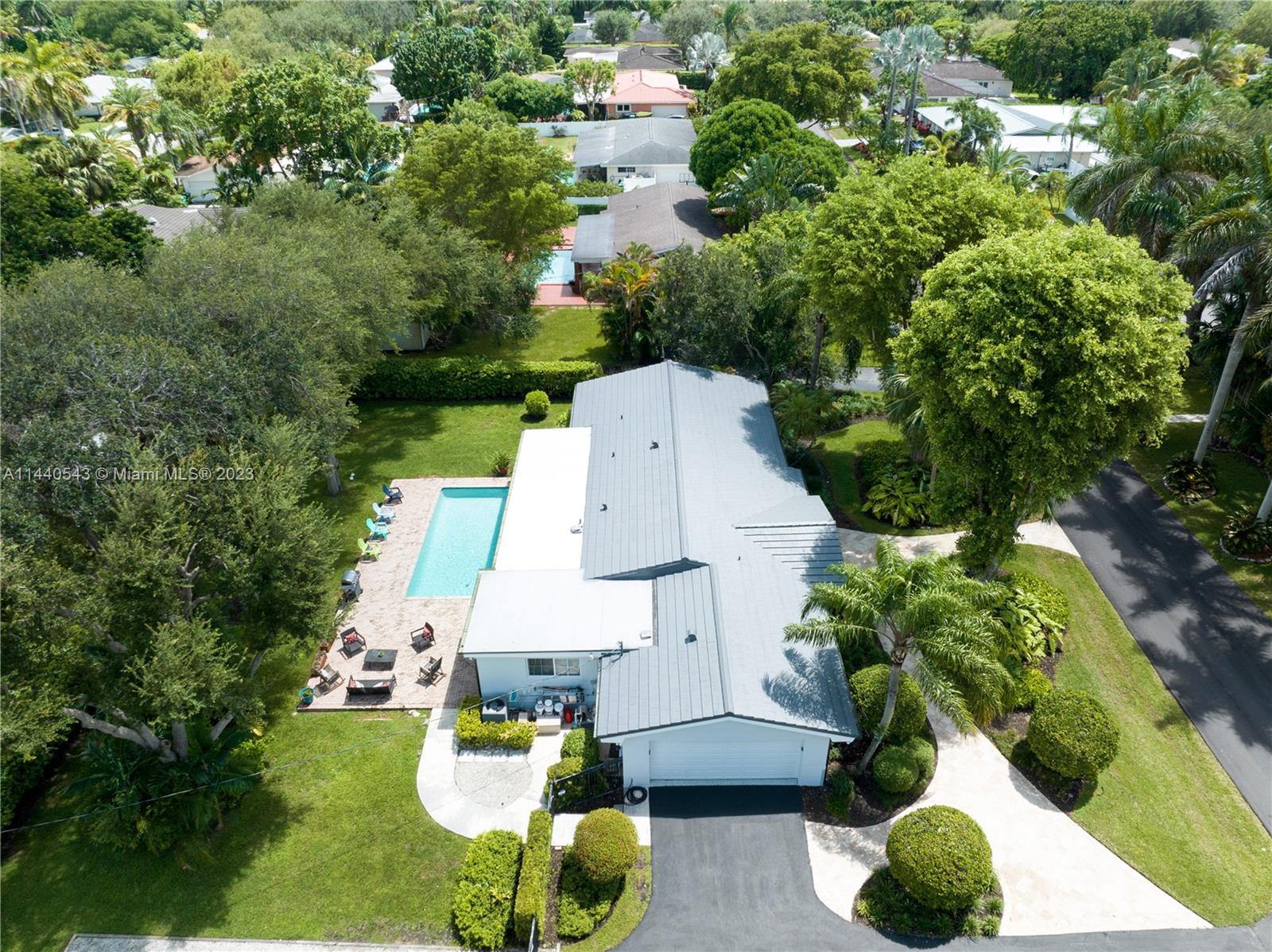 13001 Southwest 70th Avenue Pinecrest, FL 33156 - Photo 47 of 49 an aerial view of a house with yard swimming pool and outdoor seating
