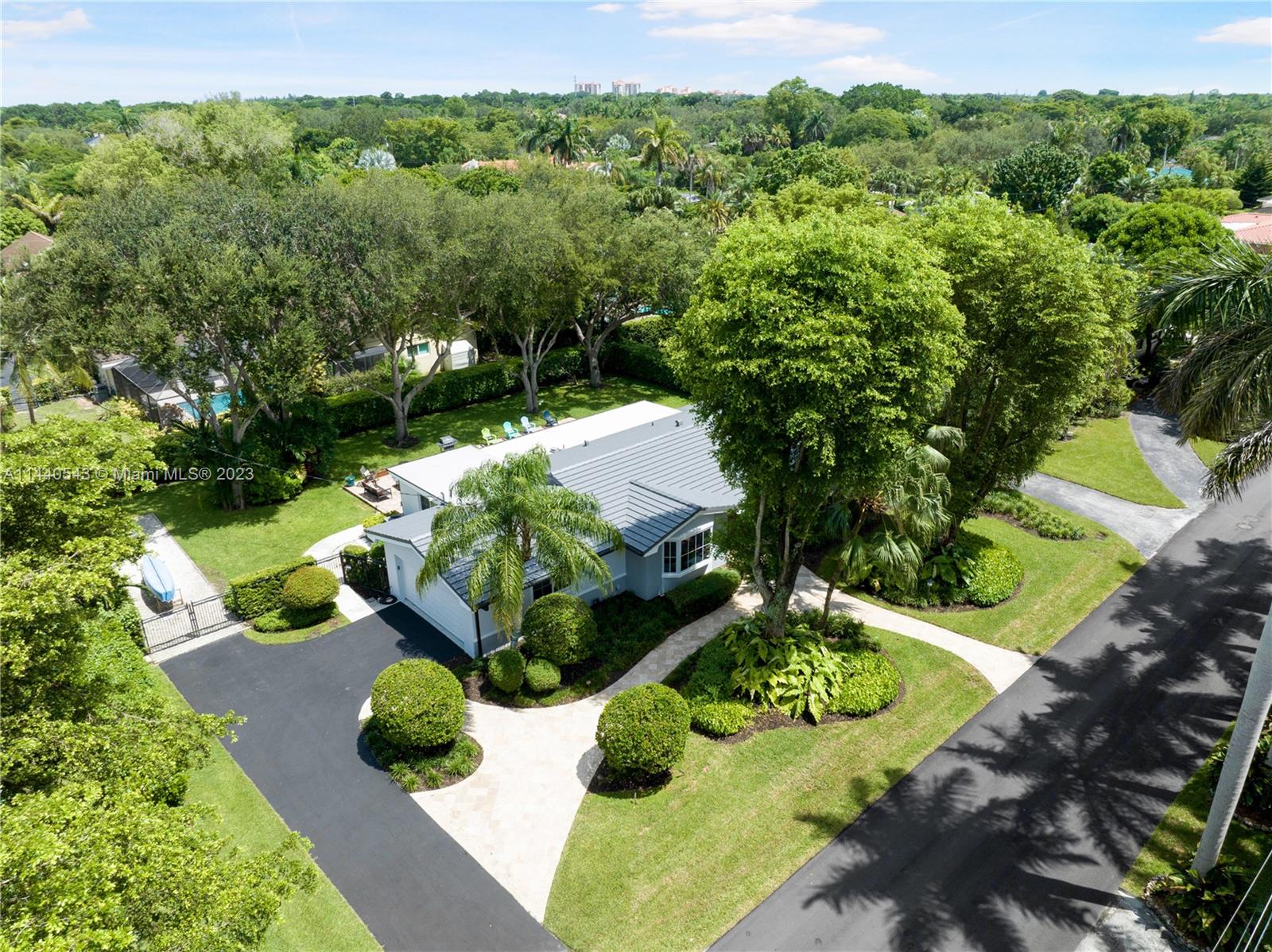 13001 Southwest 70th Avenue Pinecrest, FL 33156 - Photo 48 of 49 a view of a garden with an outdoor seating