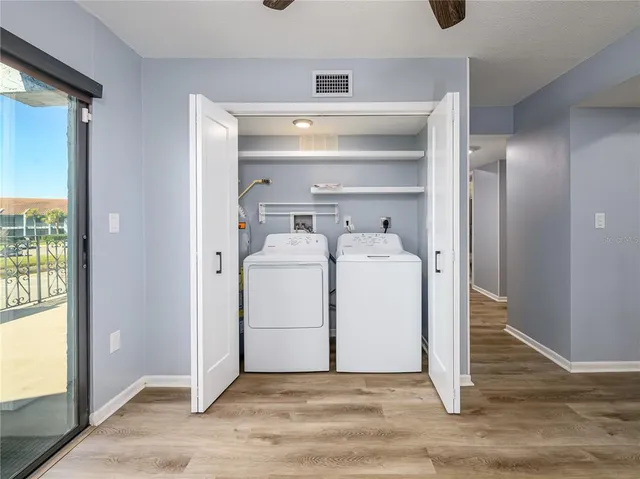a utility room with cabinets washer and dryer