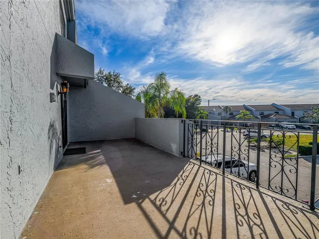 a view of balcony with wooden floor and fence