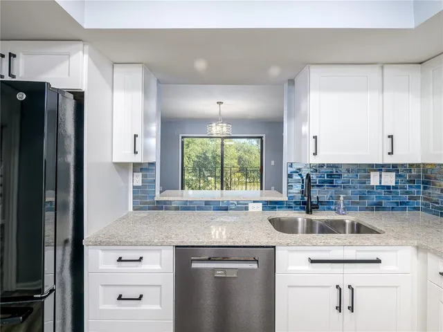 a kitchen with a sink cabinets and window