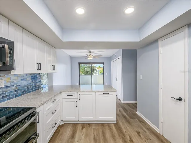 a large white kitchen with a large window