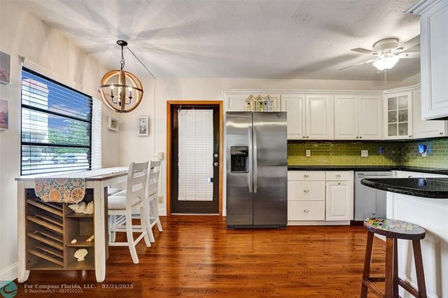 a view of a bedroom with furniture and wooden floor