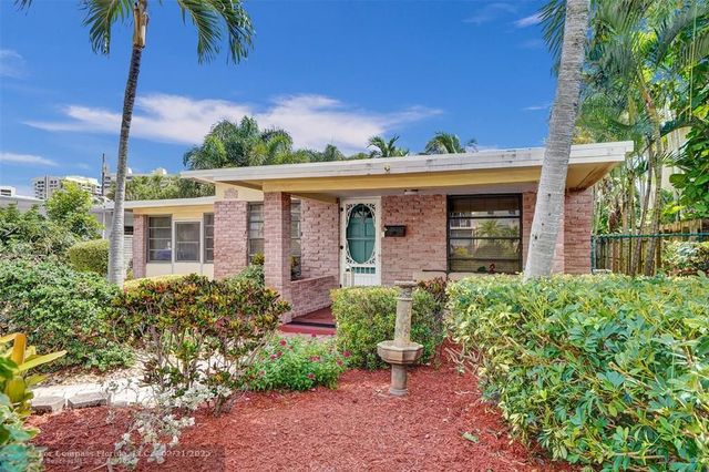 a living room with furniture a flat screen tv and a window