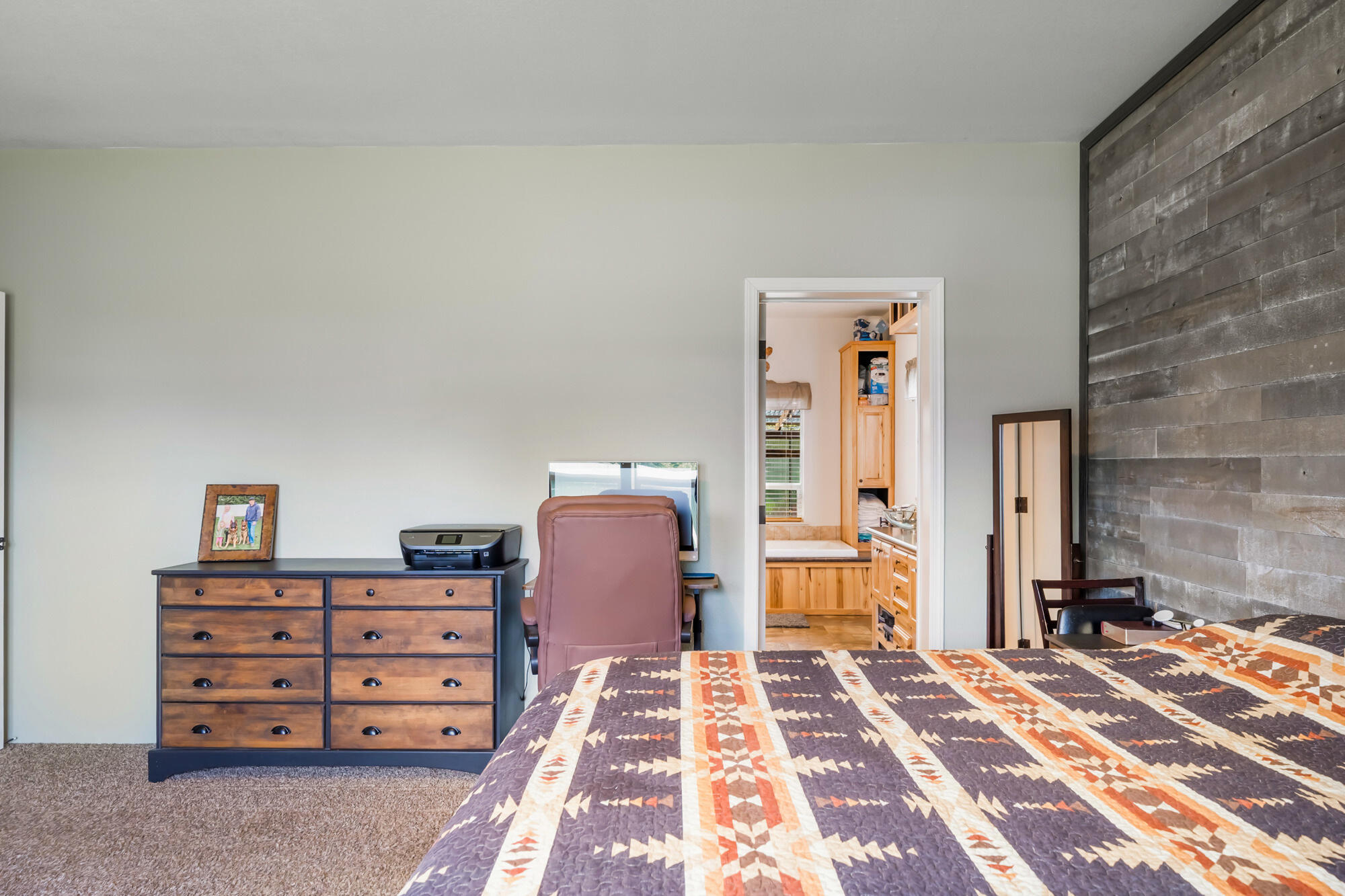 7400 South Prairie Road Tillamook, OR 97141 - Photo 47 of 62 a bedroom with a bed and a dresser