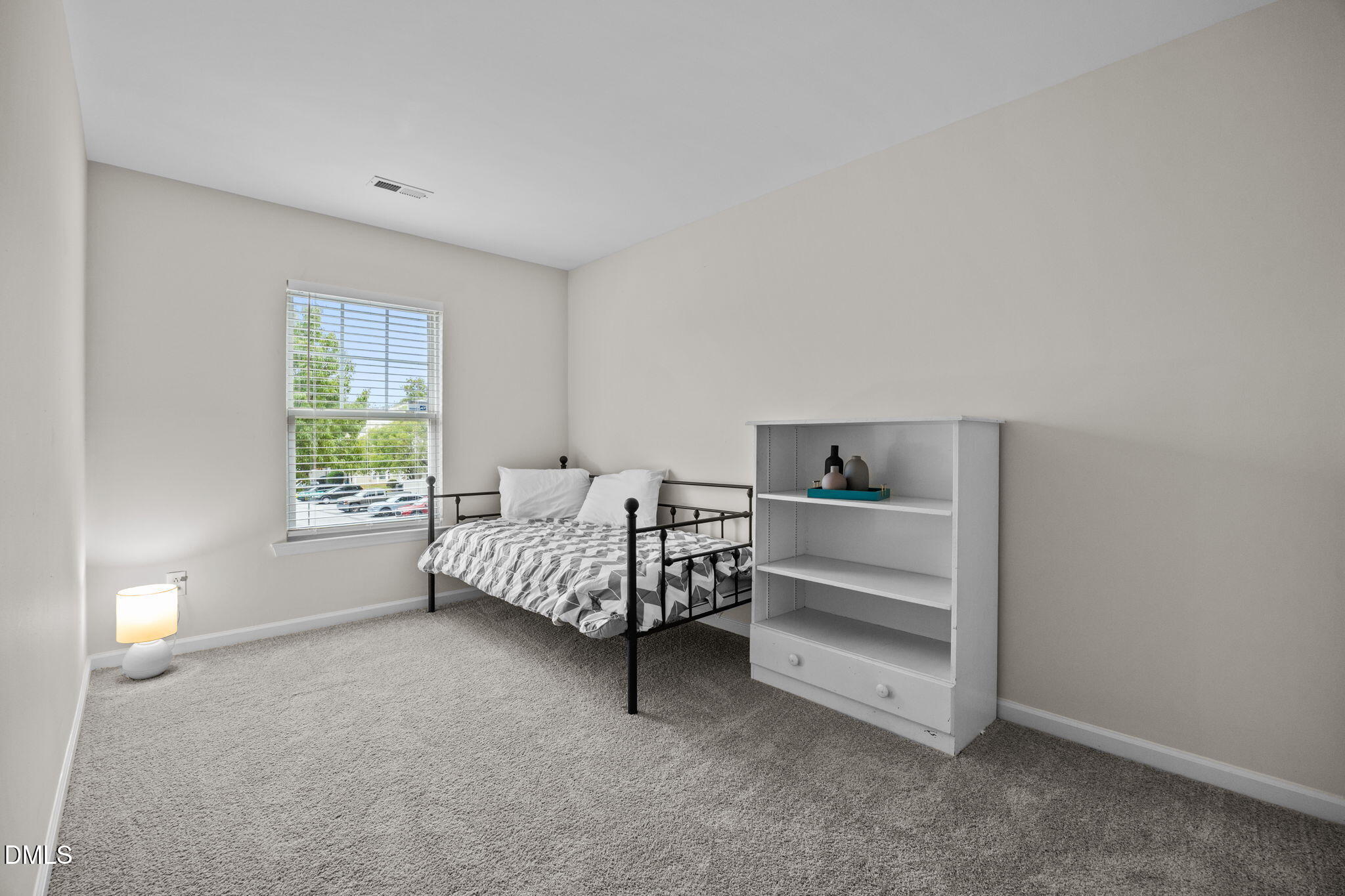 5011 Eagle Stone Lane, Unit 106 Raleigh, NC 27610 - Photo 12 of 21 a bedroom with a bed and a window