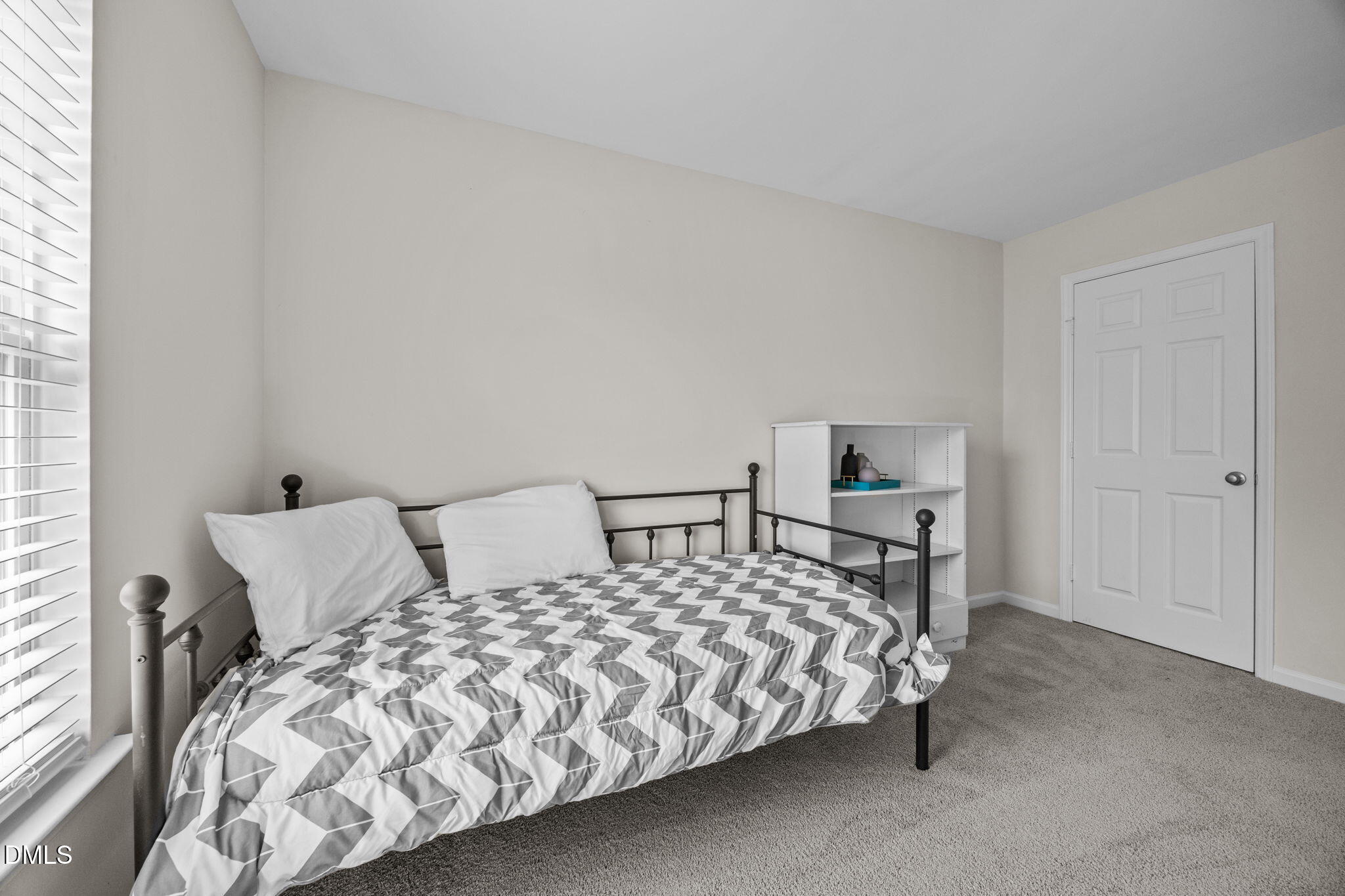5011 Eagle Stone Lane, Unit 106 Raleigh, NC 27610 - Photo 13 of 21 a bedroom with a bed and a night stand