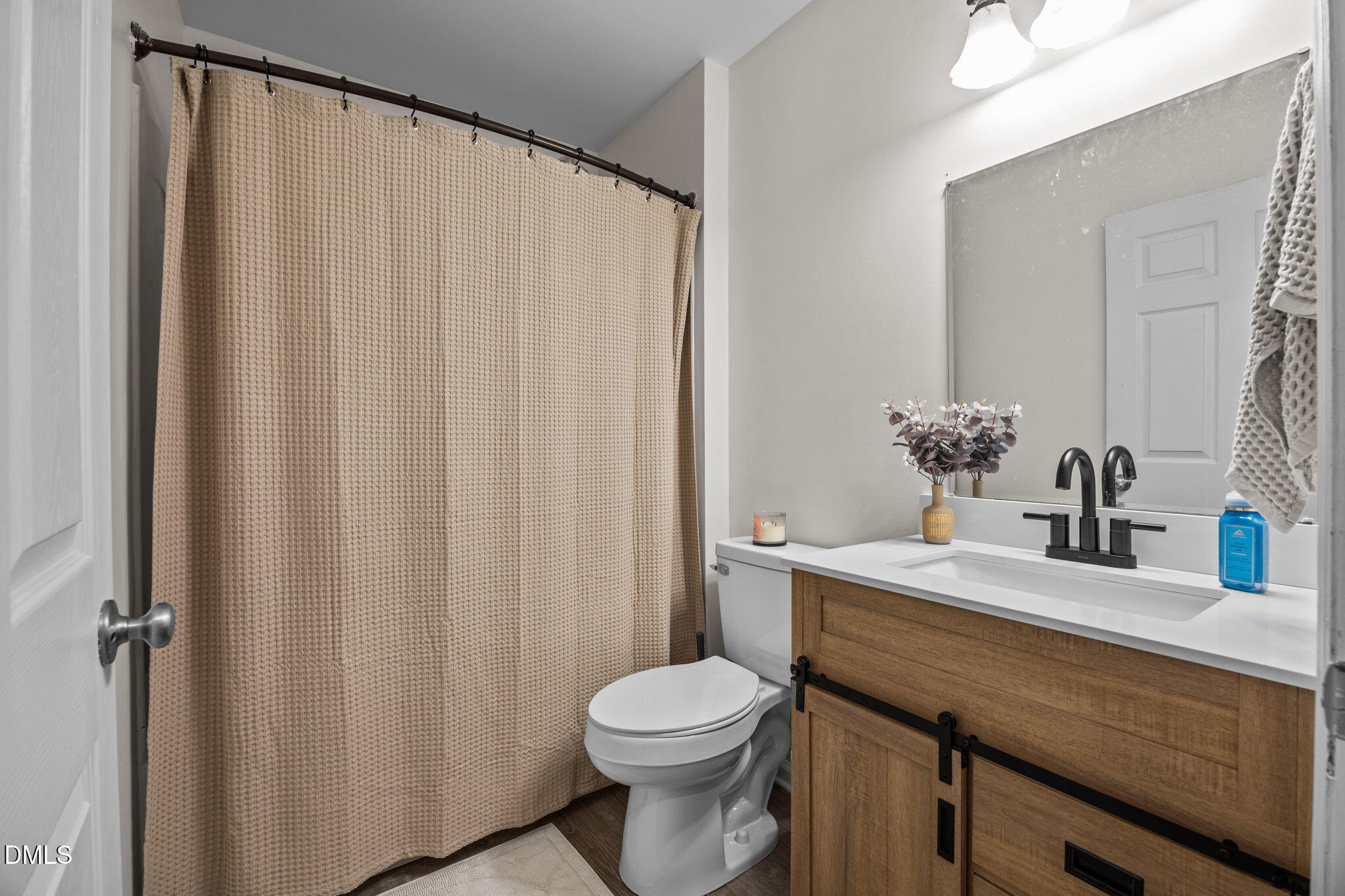 5011 Eagle Stone Lane, Unit 106 Raleigh, NC 27610 - Photo 14 of 21 a bathroom with a sink a toilet and shower curtain