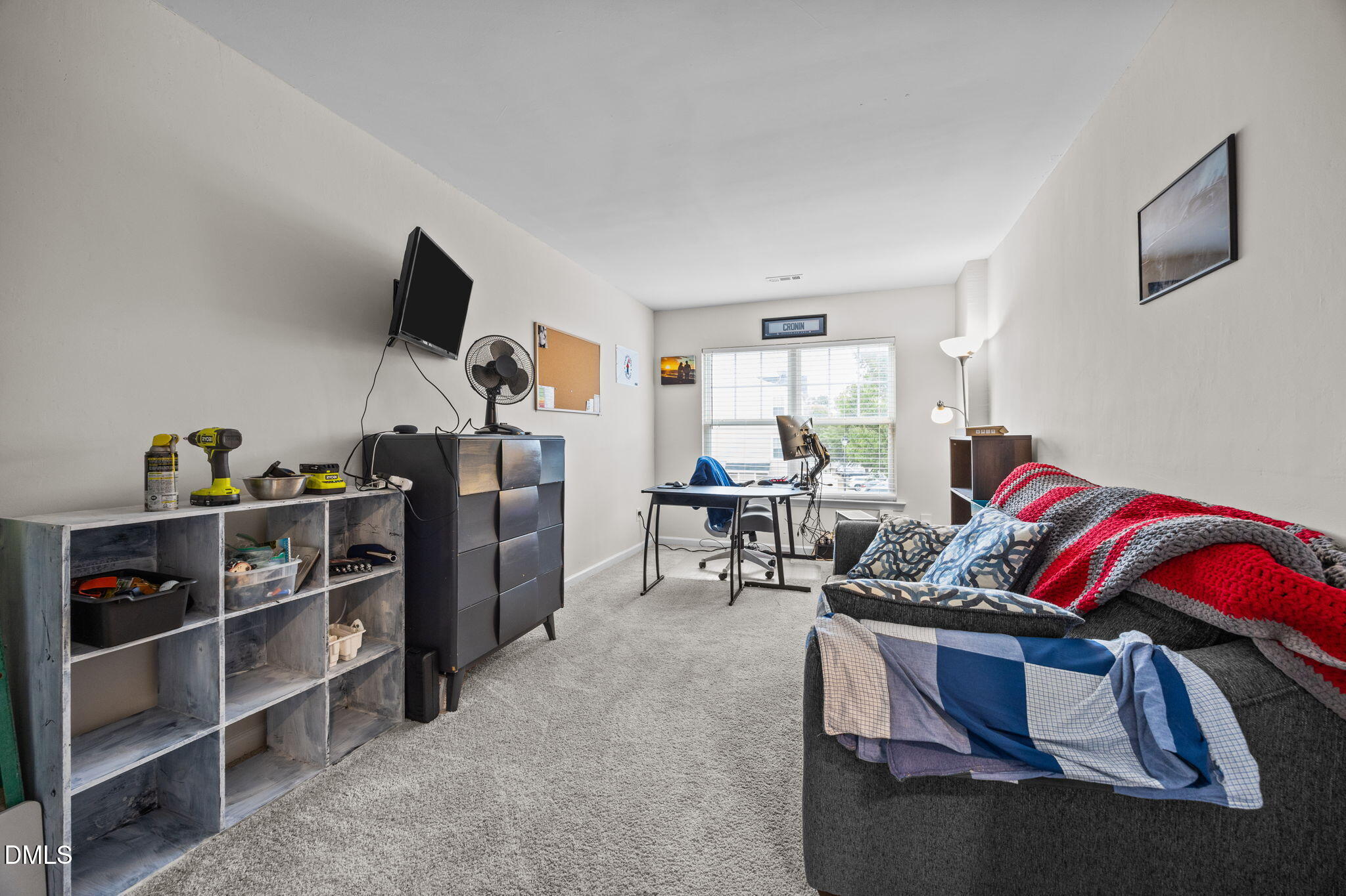 5011 Eagle Stone Lane, Unit 106 Raleigh, NC 27610 - Photo 15 of 21 a living room with furniture a flat screen tv and gym equipment