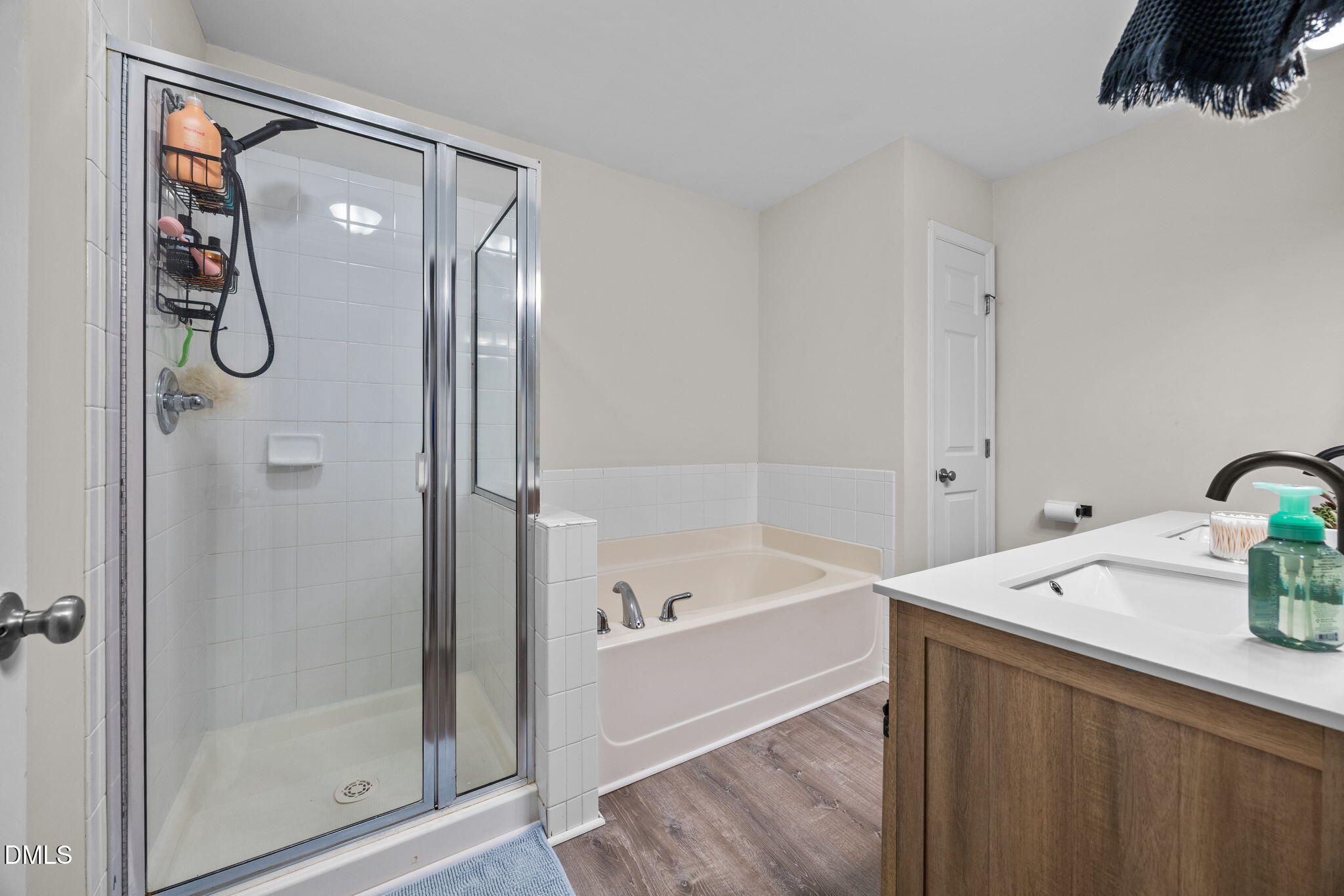 5011 Eagle Stone Lane, Unit 106 Raleigh, NC 27610 - Photo 17 of 21 a bathroom with a tub and a shower