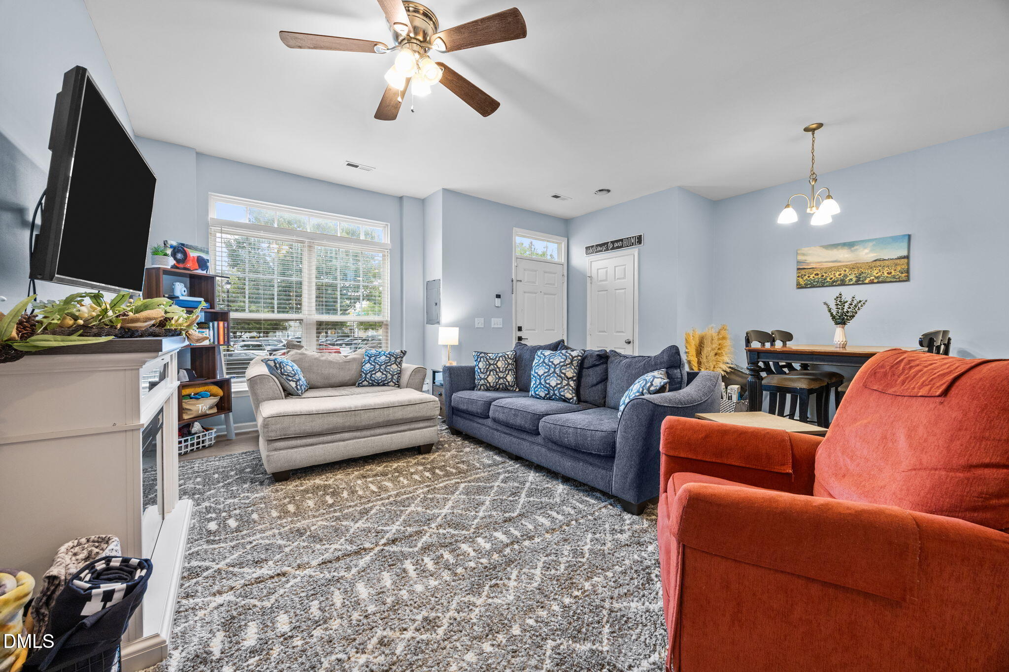 5011 Eagle Stone Lane, Unit 106 Raleigh, NC 27610 - Photo 3 of 21 a living room with furniture and a flat screen tv