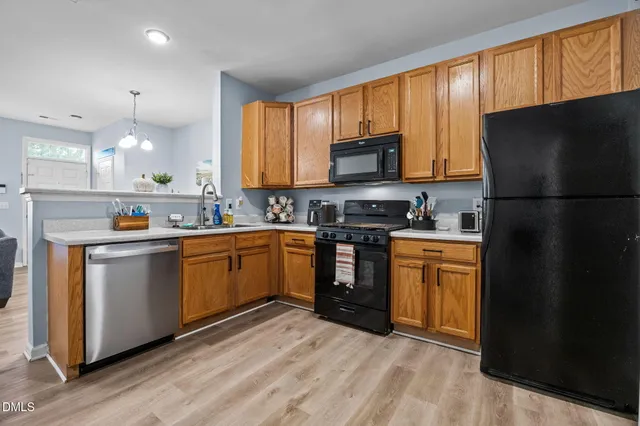 a kitchen with stainless steel appliances a refrigerator stove microwave and sink