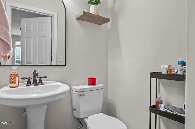 a bathroom with a sink mirror and toilet