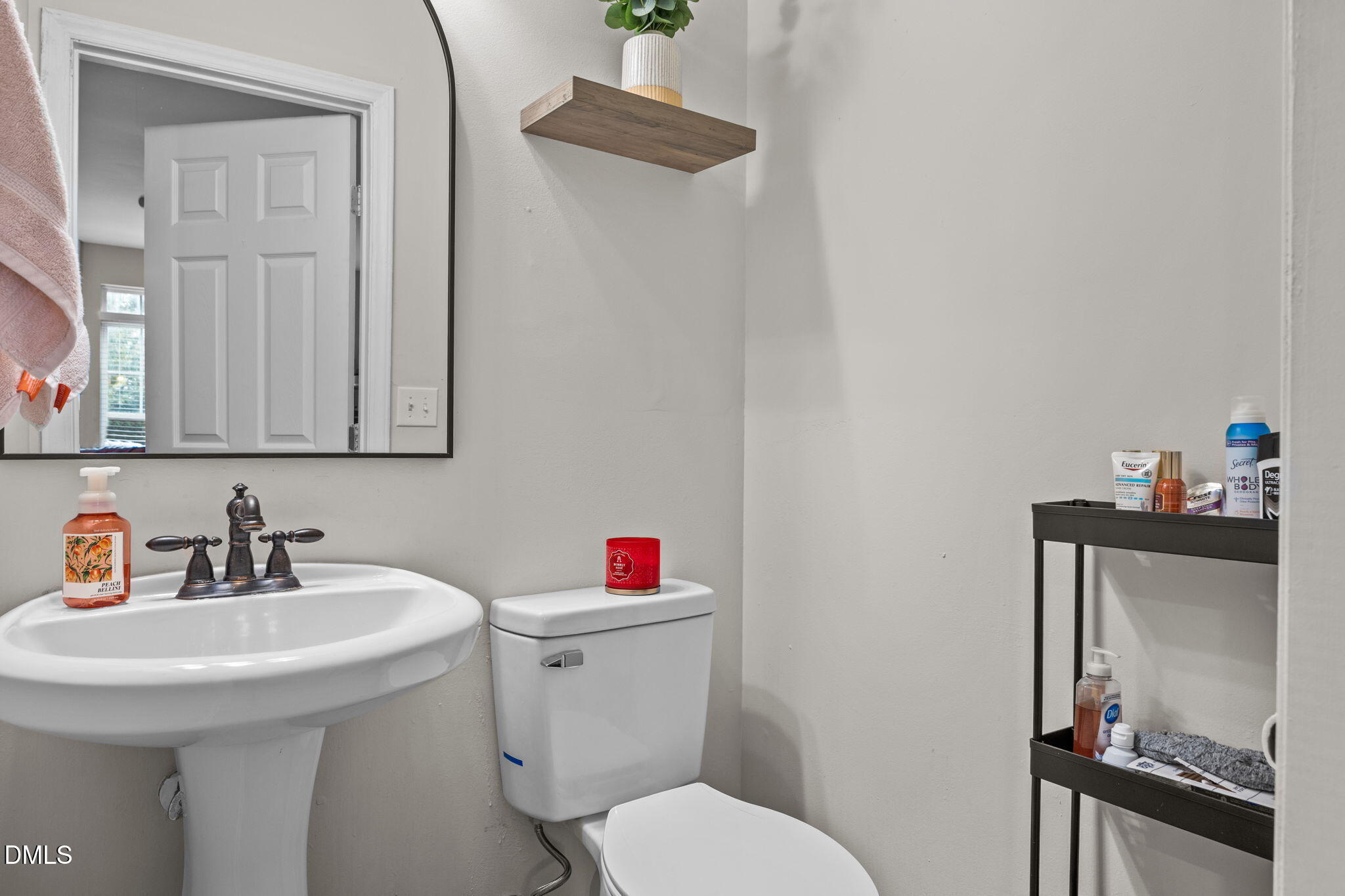 5011 Eagle Stone Lane, Unit 106 Raleigh, NC 27610 - Photo 10 of 21 a bathroom with a sink mirror and toilet