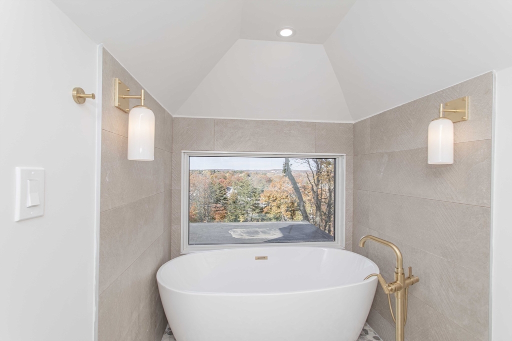 125 Mt Vernon Street, Unit 2 Newton, MA 02465 - Photo 33 of 36 a white bath tub sitting in a bathroom