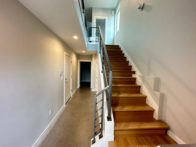 a view of entryway and hall with wooden floor