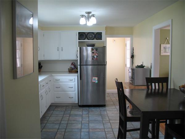 24 Maple Road Longmeadow, MA 01106 - Photo 8 of 26 a kitchen with cabinets stainless steel appliances and a dining table