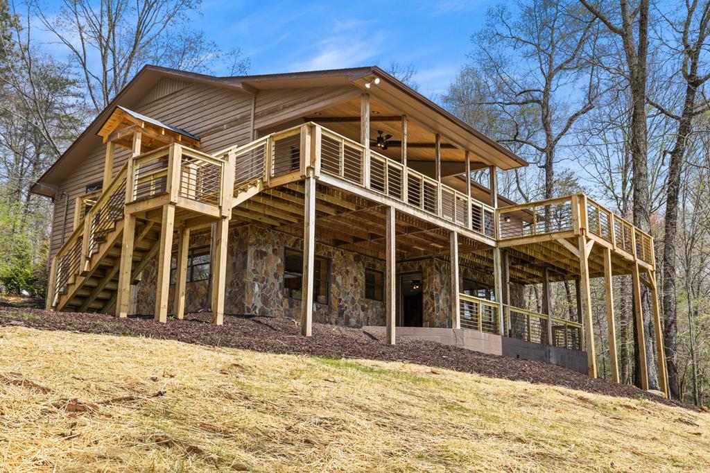 1657 Barnes Chapel Road Blue Ridge, GA 30513 - Photo 34 of 37 a view of a house with a yard and wooden fence