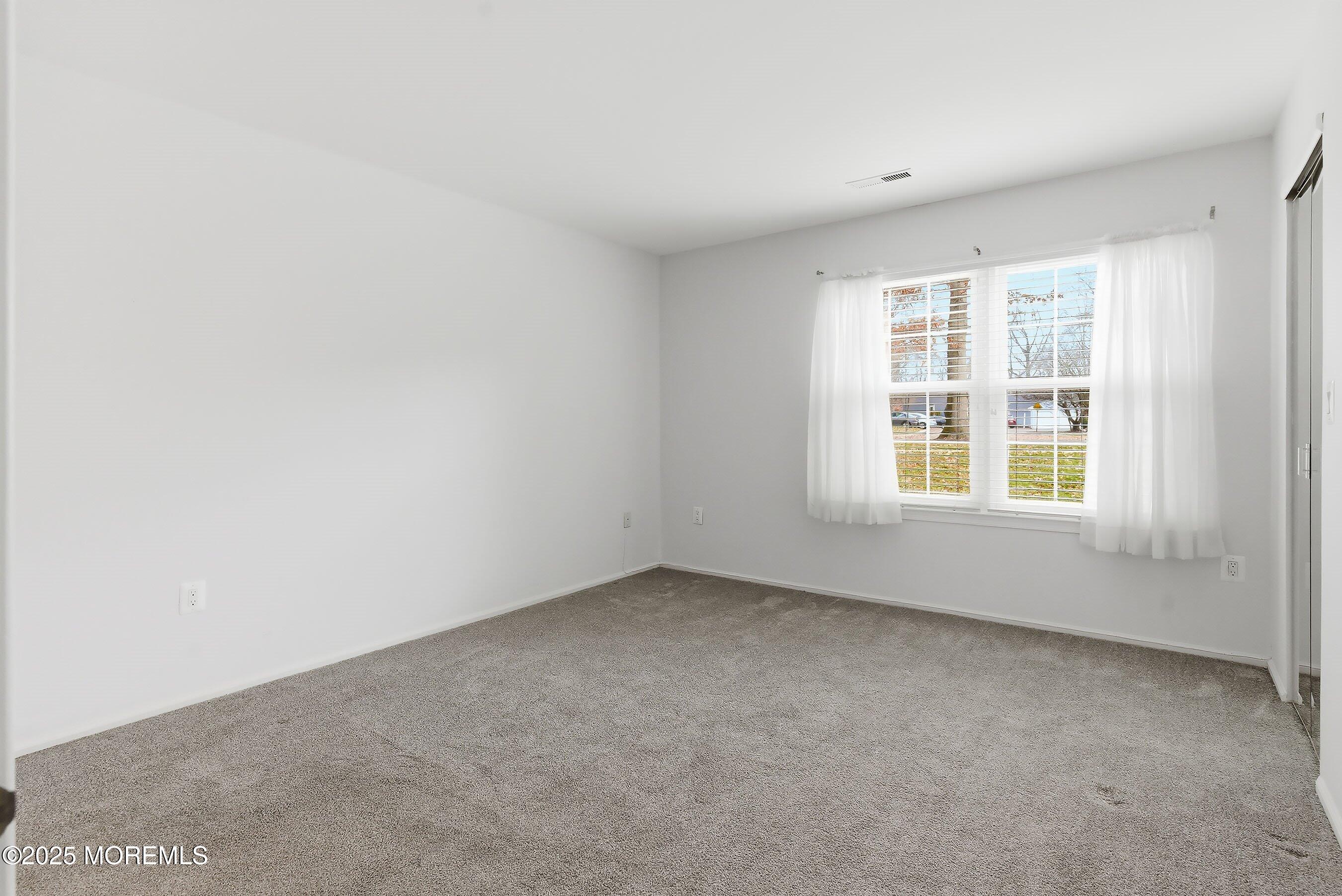 7 Boxwood Terrace, Unit 250 Red Bank, NJ 07701 - Photo 13 of 29 an empty room with a window