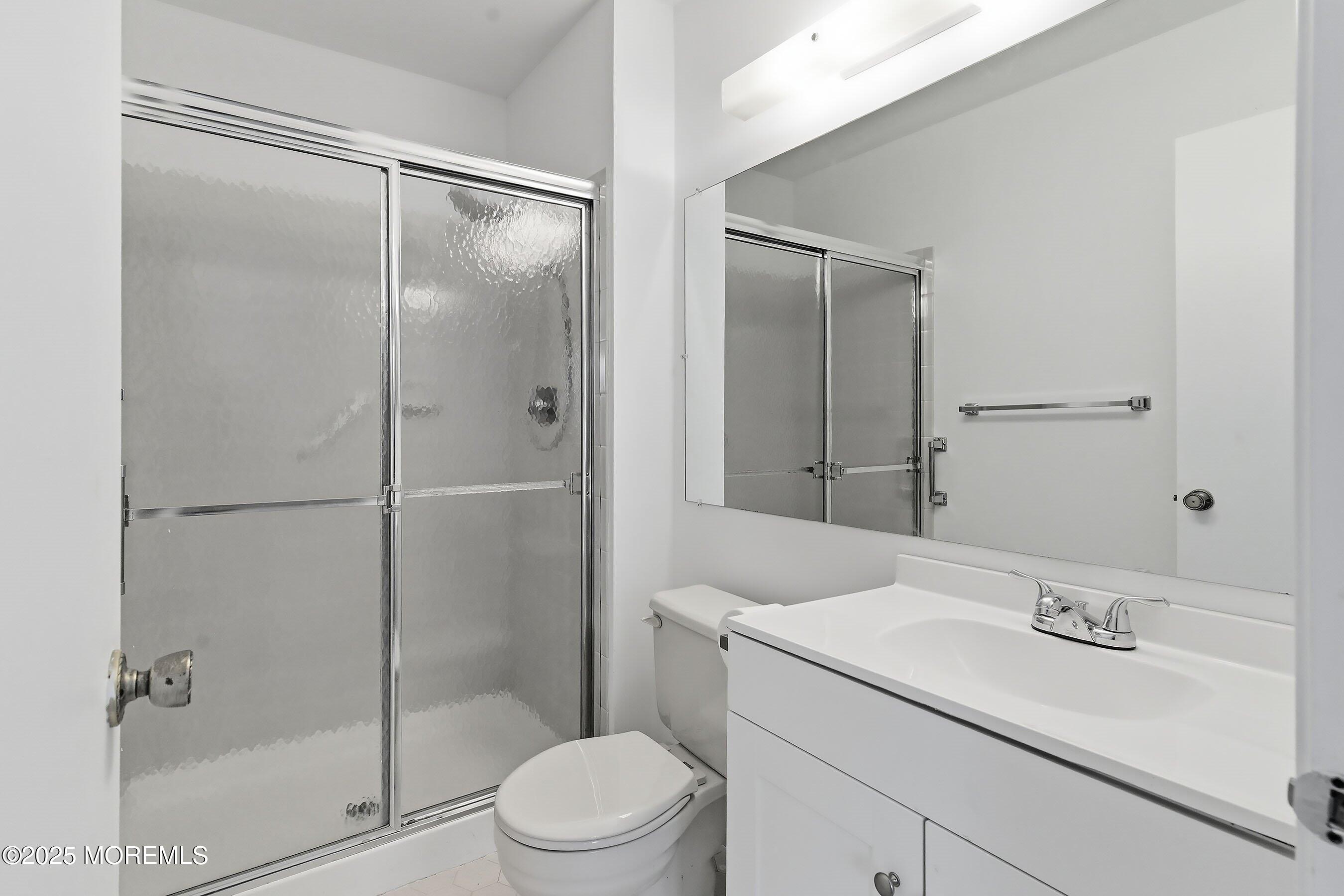 7 Boxwood Terrace, Unit 250 Red Bank, NJ 07701 - Photo 14 of 29 a bathroom with a shower sink vanity mirror and toilet