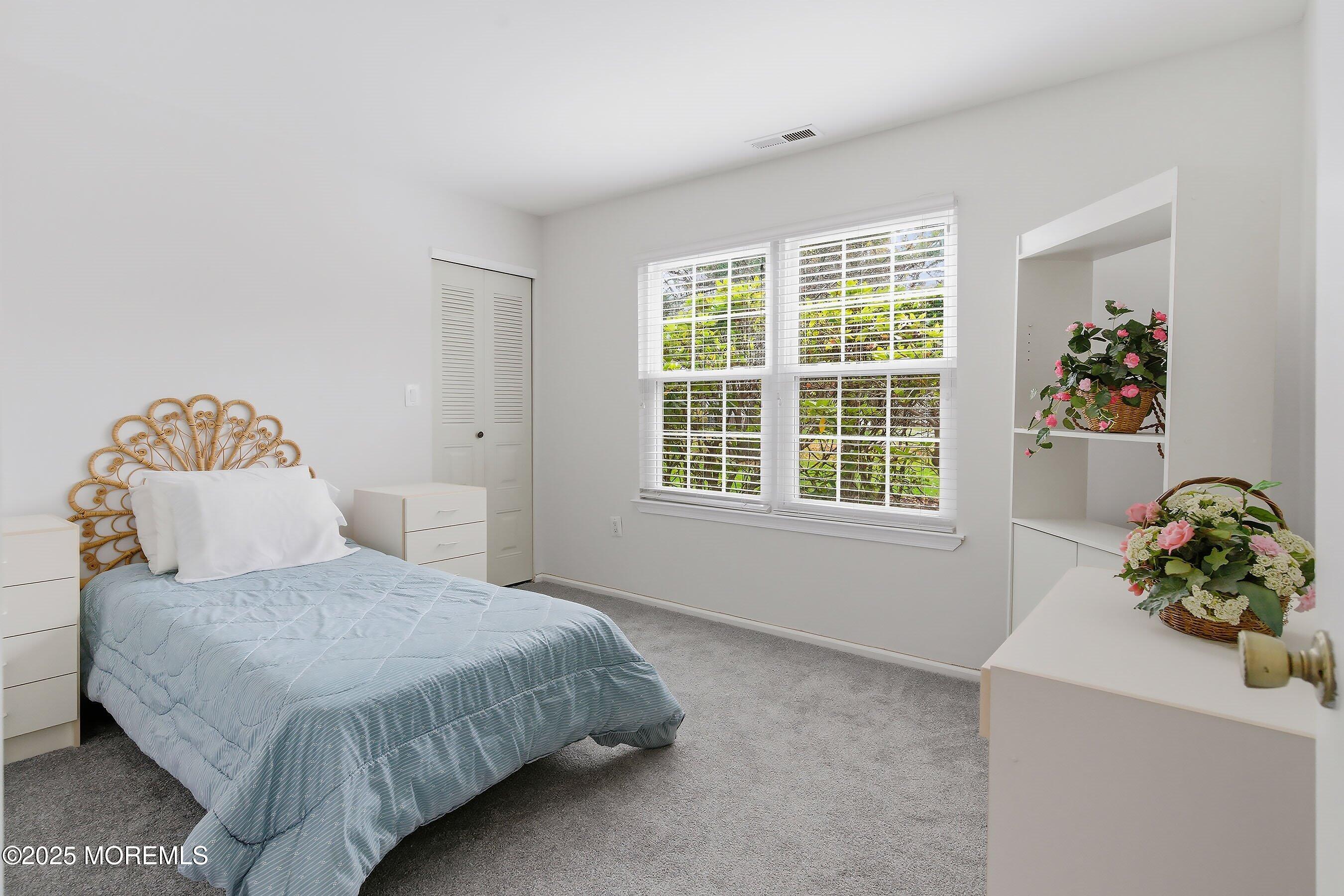 7 Boxwood Terrace, Unit 250 Red Bank, NJ 07701 - Photo 15 of 29 a bedroom with a bed and a window