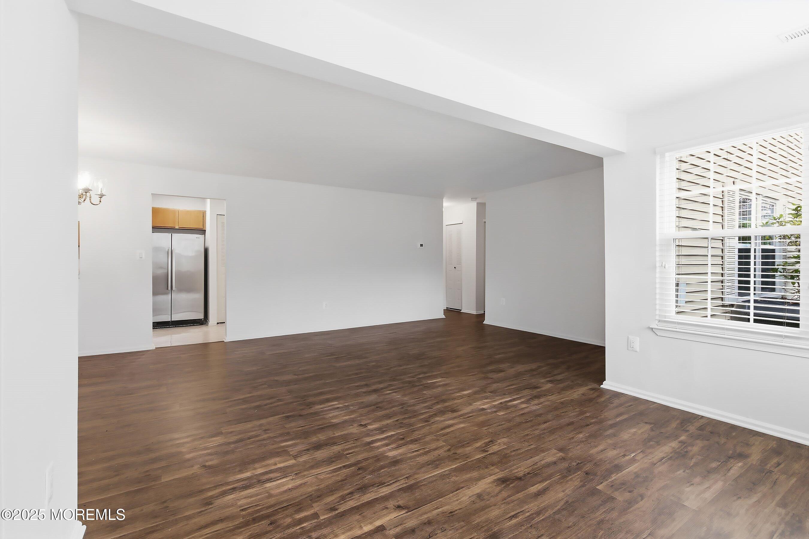 7 Boxwood Terrace, Unit 250 Red Bank, NJ 07701 - Photo 18 of 29 a view of an empty room with wooden floor and a window