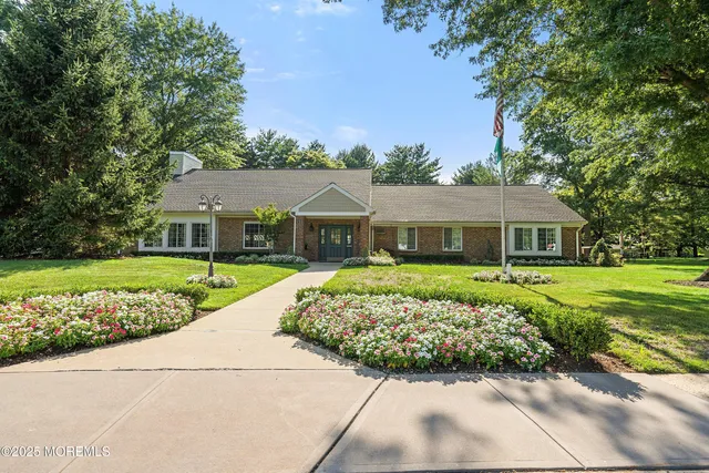 a front view of a house with a garden