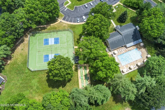 an aerial view of a house with a yard and garden