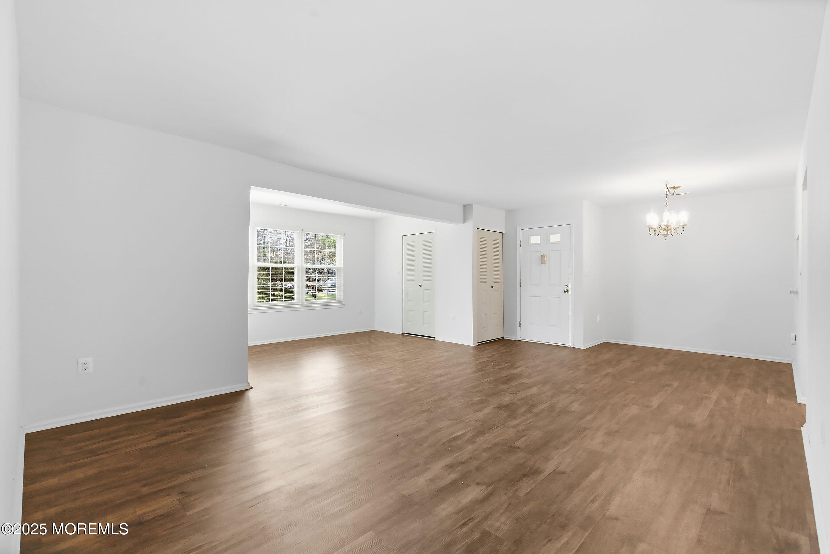 7 Boxwood Terrace, Unit 250 Red Bank, NJ 07701 - Photo 3 of 29 a view of an empty room with wooden floor and a window