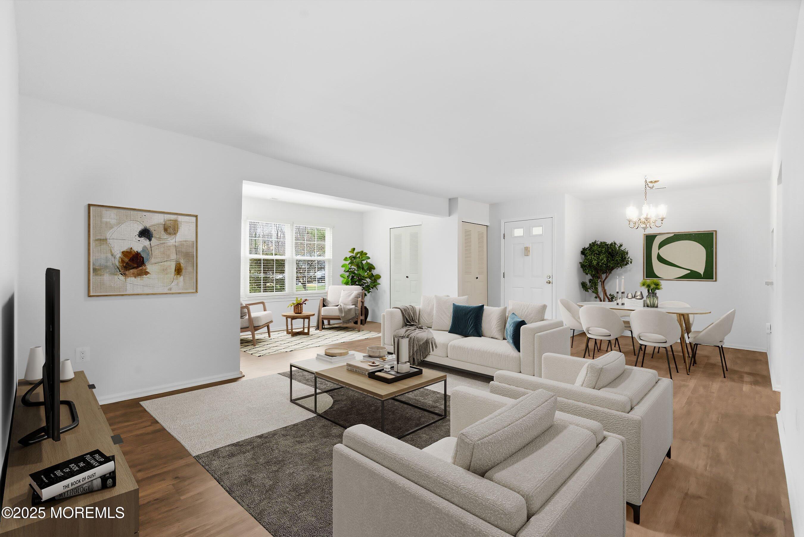 7 Boxwood Terrace, Unit 250 Red Bank, NJ 07701 - Photo 4 of 29 a living room with furniture and a flat screen tv with kitchen view